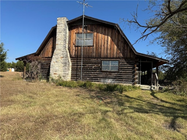 view of side of home featuring a lawn