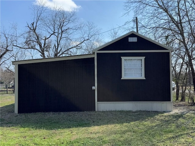 view of outbuilding featuring a yard