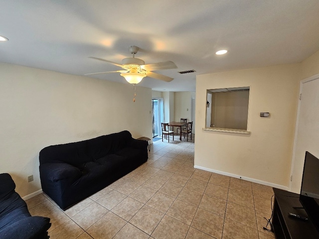 living room featuring ceiling fan and light tile patterned flooring