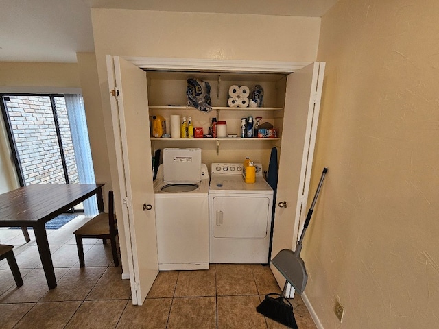 laundry area featuring tile patterned flooring and washing machine and clothes dryer