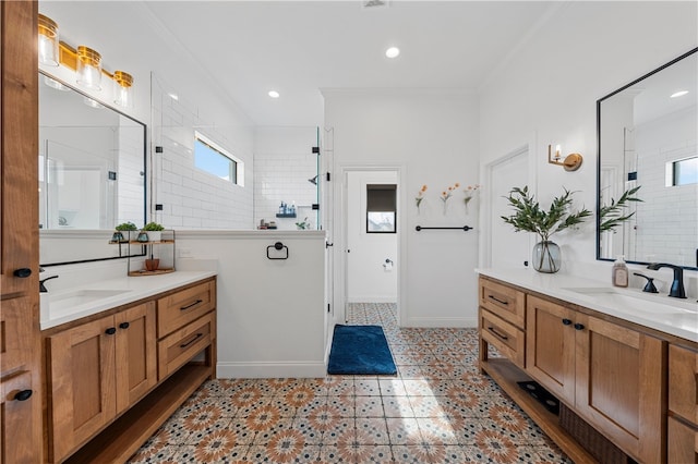 bathroom with vanity, tiled shower, and crown molding