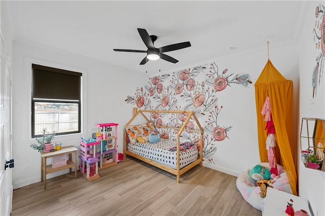 bedroom featuring ceiling fan, light hardwood / wood-style floors, and ornamental molding