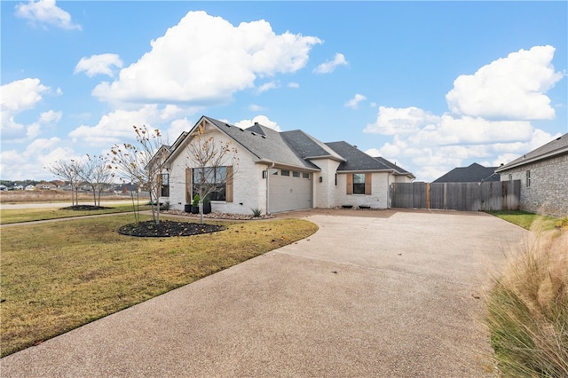 view of front of property featuring a garage and a front yard