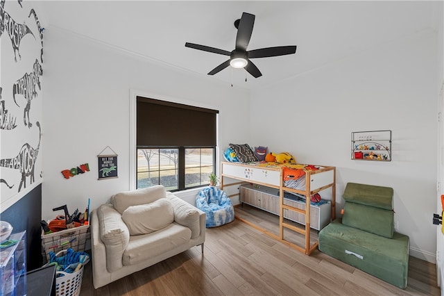 bedroom with ceiling fan, crown molding, and light wood-type flooring