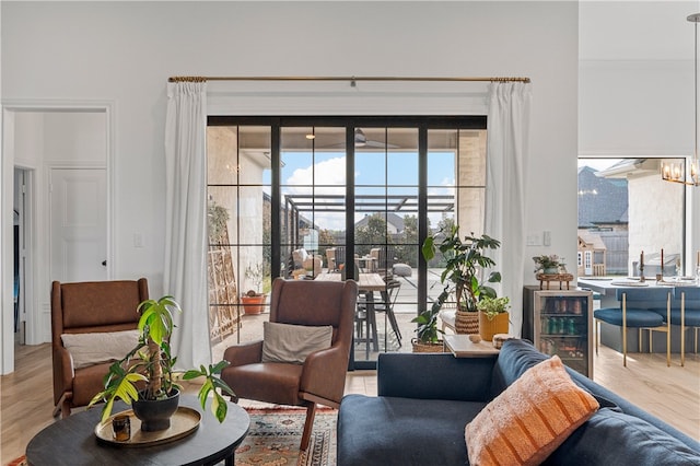 interior space featuring wine cooler, a notable chandelier, and light wood-type flooring