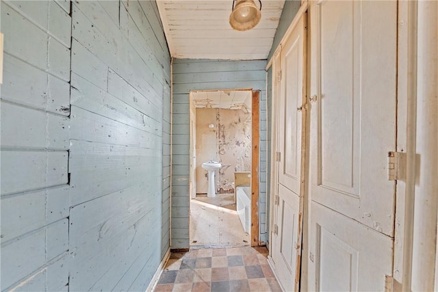 hall with wooden ceiling and wood walls