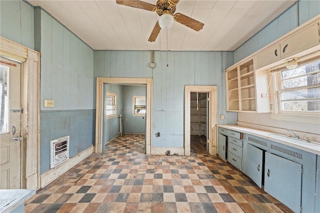 kitchen featuring ceiling fan, sink, and heating unit