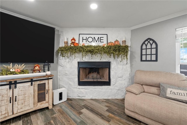 living room with wood-type flooring and ornamental molding