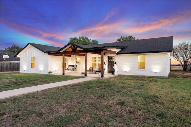 modern farmhouse featuring a yard and a patio