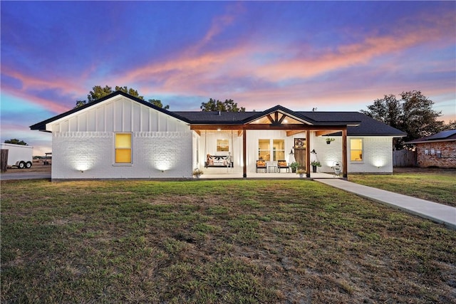 modern farmhouse style home featuring a yard