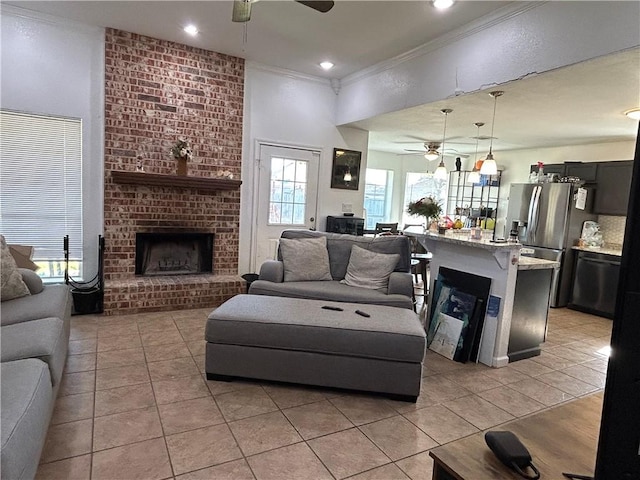 living room featuring a fireplace, crown molding, light tile patterned floors, recessed lighting, and a ceiling fan