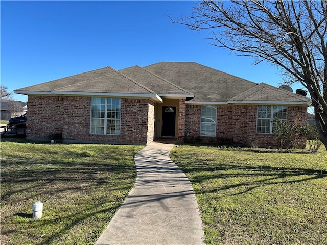 ranch-style house with brick siding and a front yard