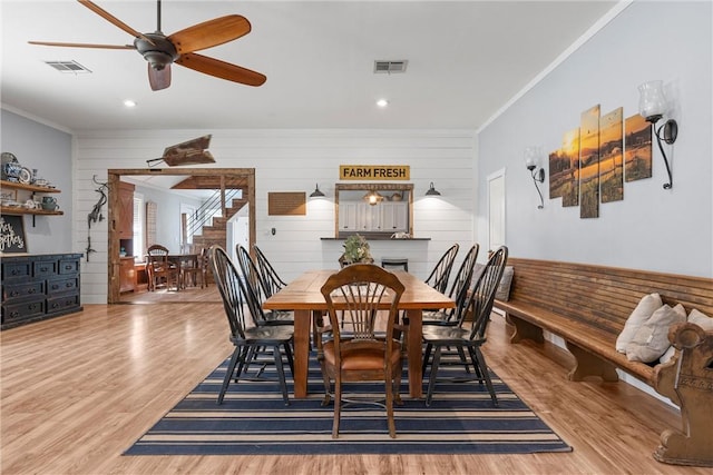 dining room featuring ornamental molding, visible vents, and wood finished floors