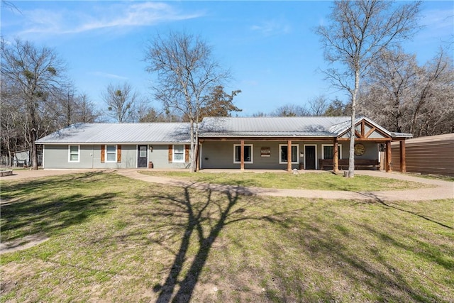 ranch-style house with metal roof and a front lawn