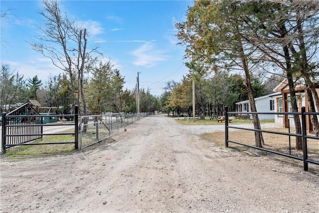 view of street featuring a gated entry and a gate