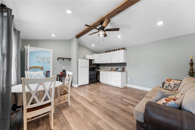 living area with baseboards, ceiling fan, lofted ceiling with beams, and light wood finished floors