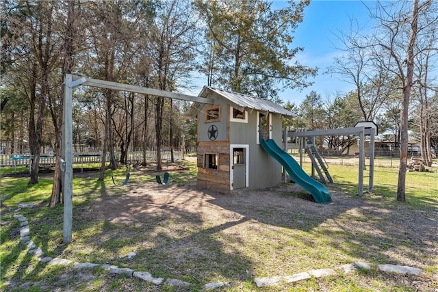 view of play area with a trampoline, a yard, and fence