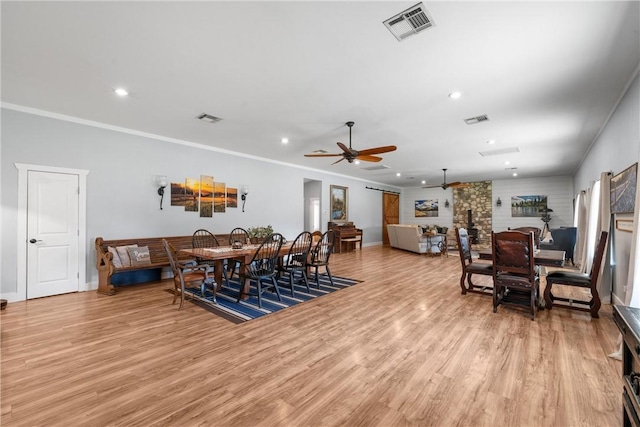 dining space featuring light wood-style floors and visible vents