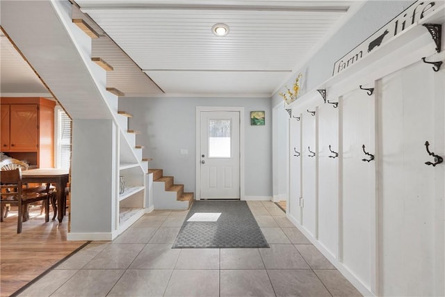 mudroom featuring baseboards and light tile patterned floors