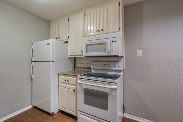 kitchen featuring white appliances and dark wood-type flooring