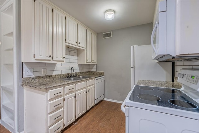 kitchen with white cabinetry, sink, and white appliances