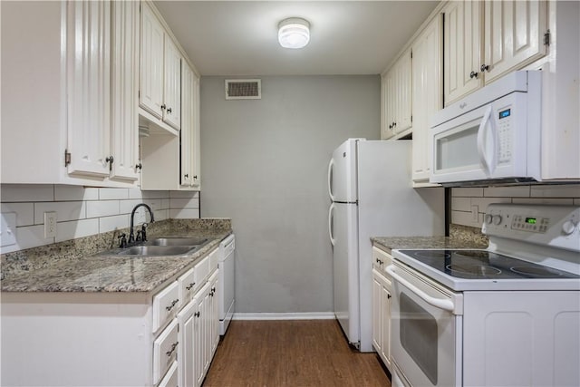 kitchen with white appliances, white cabinets, sink, dark hardwood / wood-style floors, and decorative backsplash