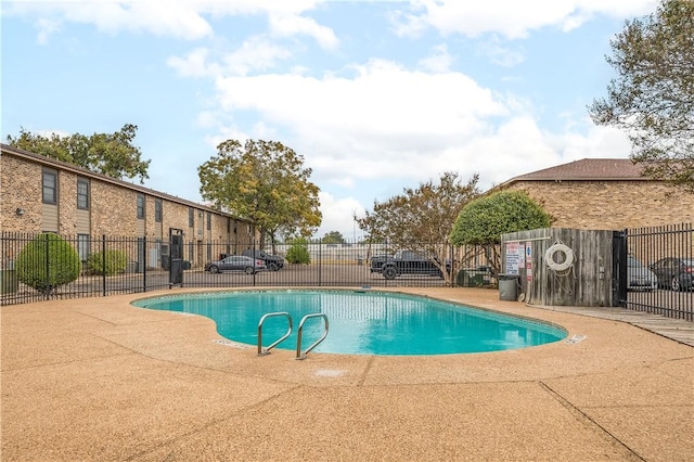 view of swimming pool with a patio