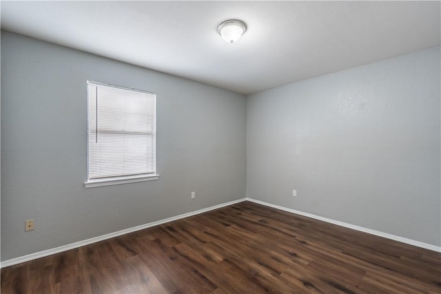 empty room featuring dark hardwood / wood-style flooring