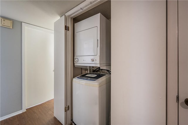 laundry area with wood-type flooring and stacked washer and clothes dryer