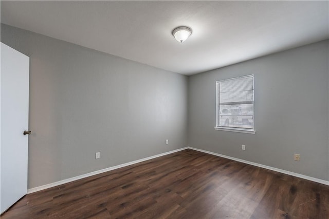 unfurnished room featuring dark wood-type flooring