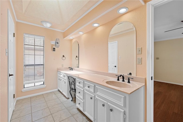 bathroom with tile patterned floors, a textured ceiling, vanity, ceiling fan, and crown molding