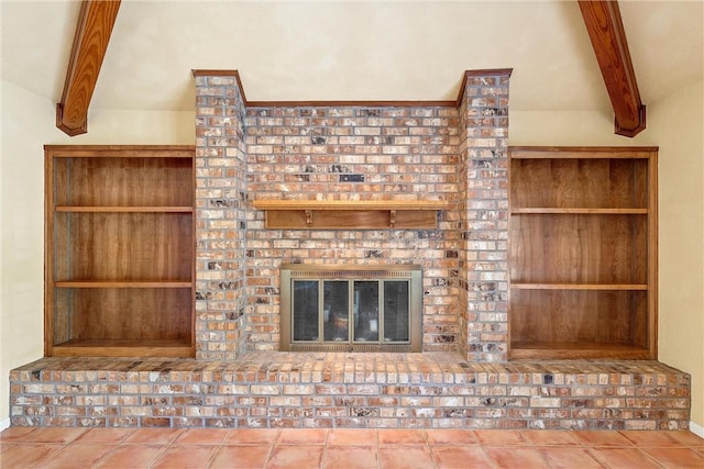 unfurnished living room featuring a fireplace, vaulted ceiling with beams, and tile patterned flooring