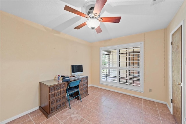 tiled home office featuring ceiling fan