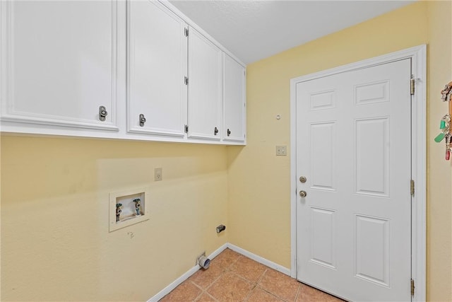 laundry area with washer hookup, cabinets, and light tile patterned floors