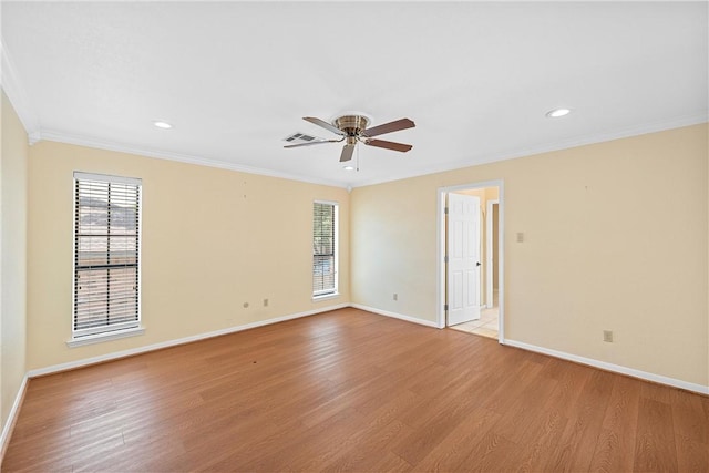 spare room featuring ceiling fan, ornamental molding, and light hardwood / wood-style flooring