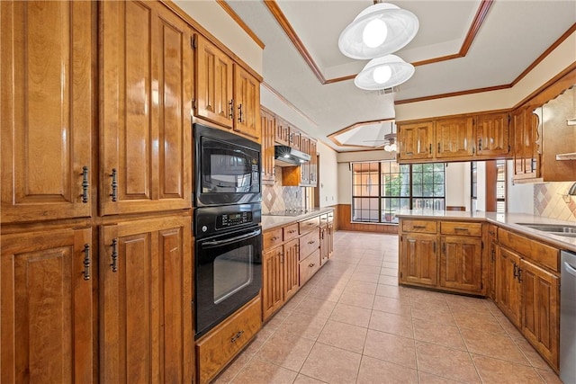 kitchen featuring decorative backsplash, a tray ceiling, sink, black appliances, and light tile patterned flooring