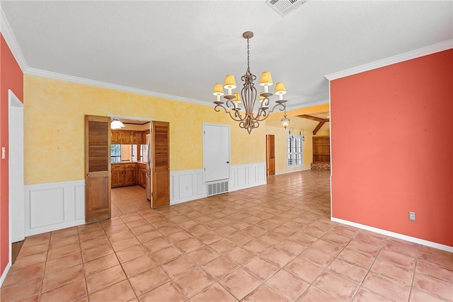 spare room featuring ceiling fan with notable chandelier and crown molding