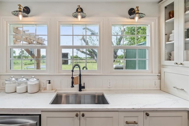 kitchen featuring white cabinetry, a healthy amount of sunlight, and sink