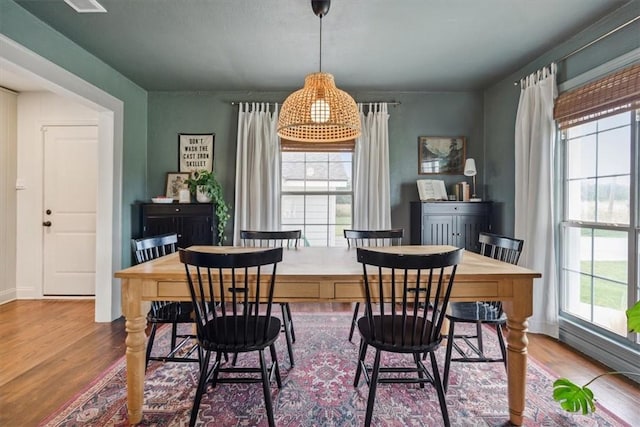 dining space with hardwood / wood-style floors and plenty of natural light