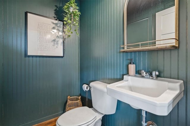 bathroom featuring hardwood / wood-style flooring, toilet, and sink