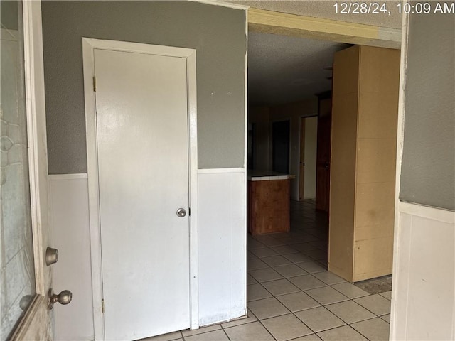 hallway featuring light tile patterned floors