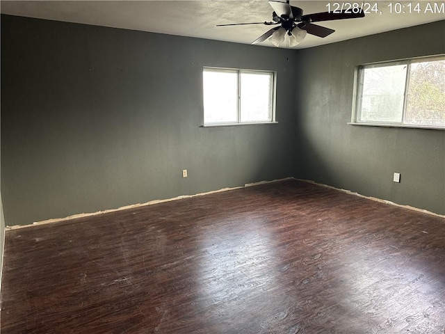 empty room with dark wood-type flooring and ceiling fan