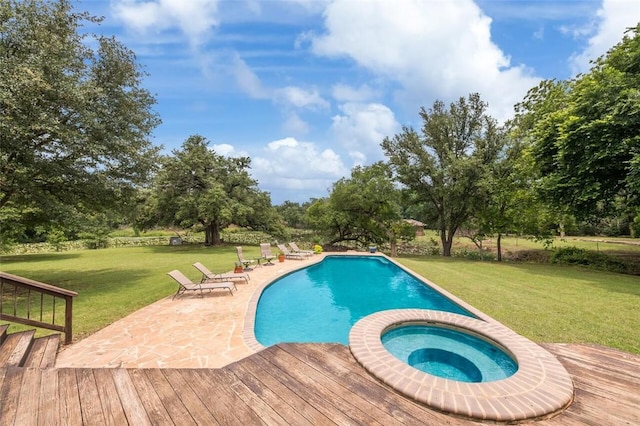 view of pool with an in ground hot tub, a patio area, and a lawn