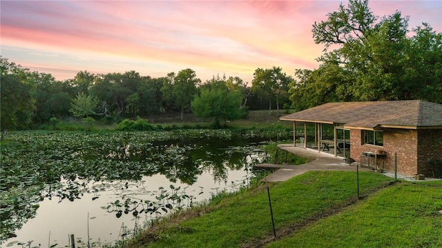 exterior space with a water view and a yard