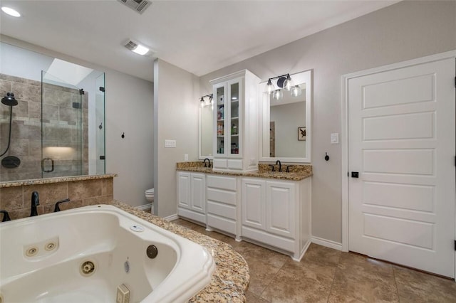 full bathroom featuring a skylight, tile patterned flooring, separate shower and tub, toilet, and vanity