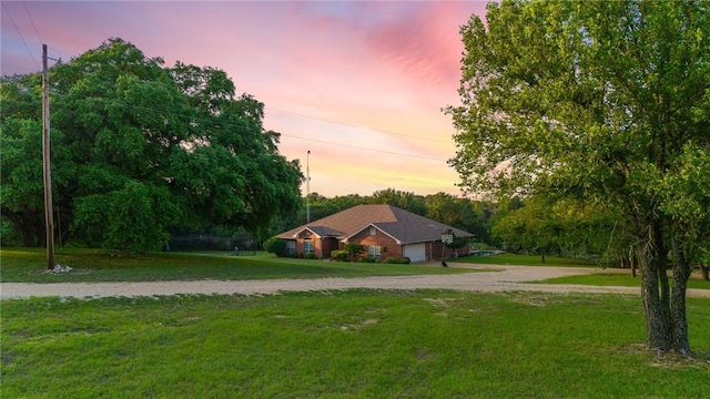 single story home with a lawn