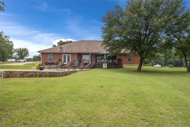 view of yard featuring french doors and a deck