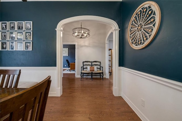 hall with dark hardwood / wood-style floors and an inviting chandelier