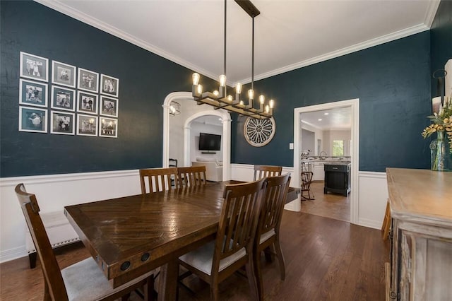 dining area featuring hardwood / wood-style floors and crown molding