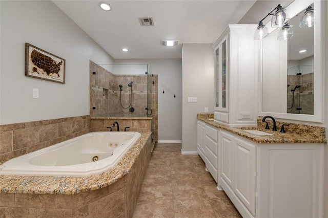 bathroom featuring tile patterned floors, vanity, and shower with separate bathtub